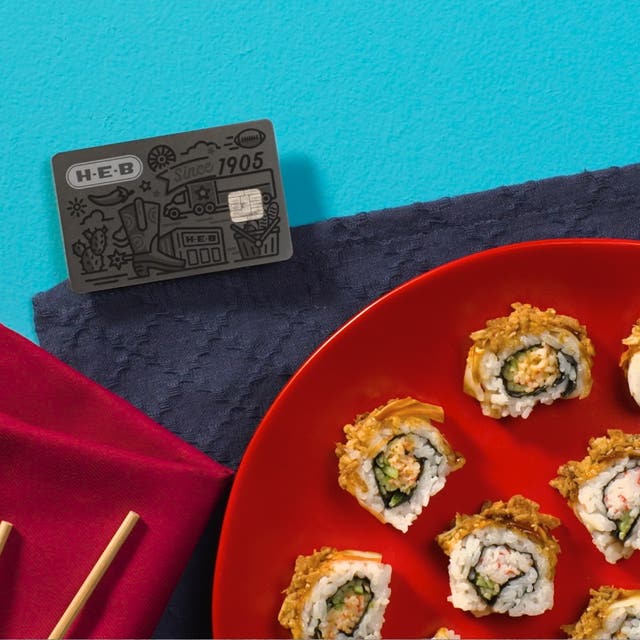 H‑E‑B Credit Card and sushi with chopsticks on a napkin