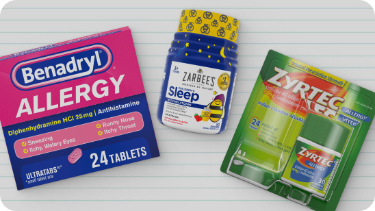 Box of Benadryl allergy medication photographed with a container of Zarbees children's sleep aid and a package of Zyrtec allergy medication 