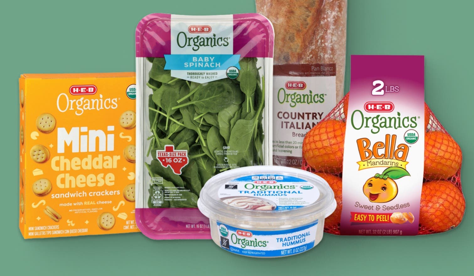 A group of H‑E‑B Organics products including Mini Cheddar Cheese Crackers, Baby Spinach, Country Italian Bread, Bella Mandarins and Traditional Hummus.