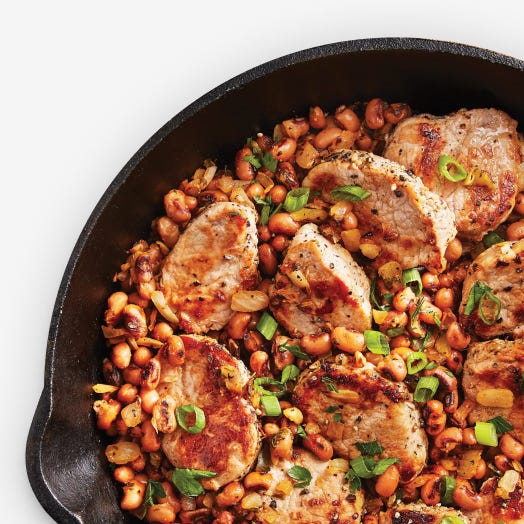 Skillet with beans and chicken on top