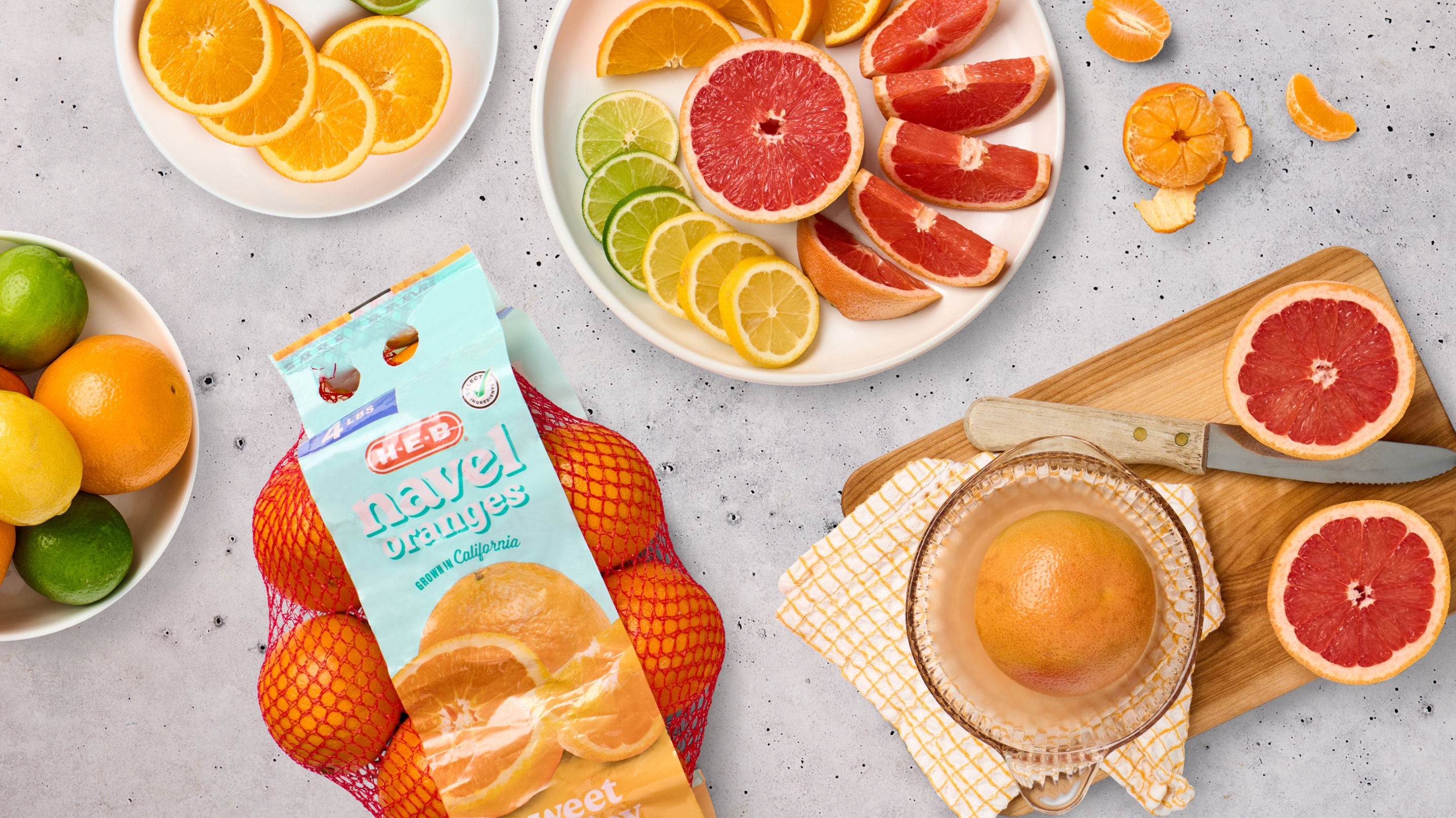 Oranges, limes, lemons, grapefruit all together laid out on a table