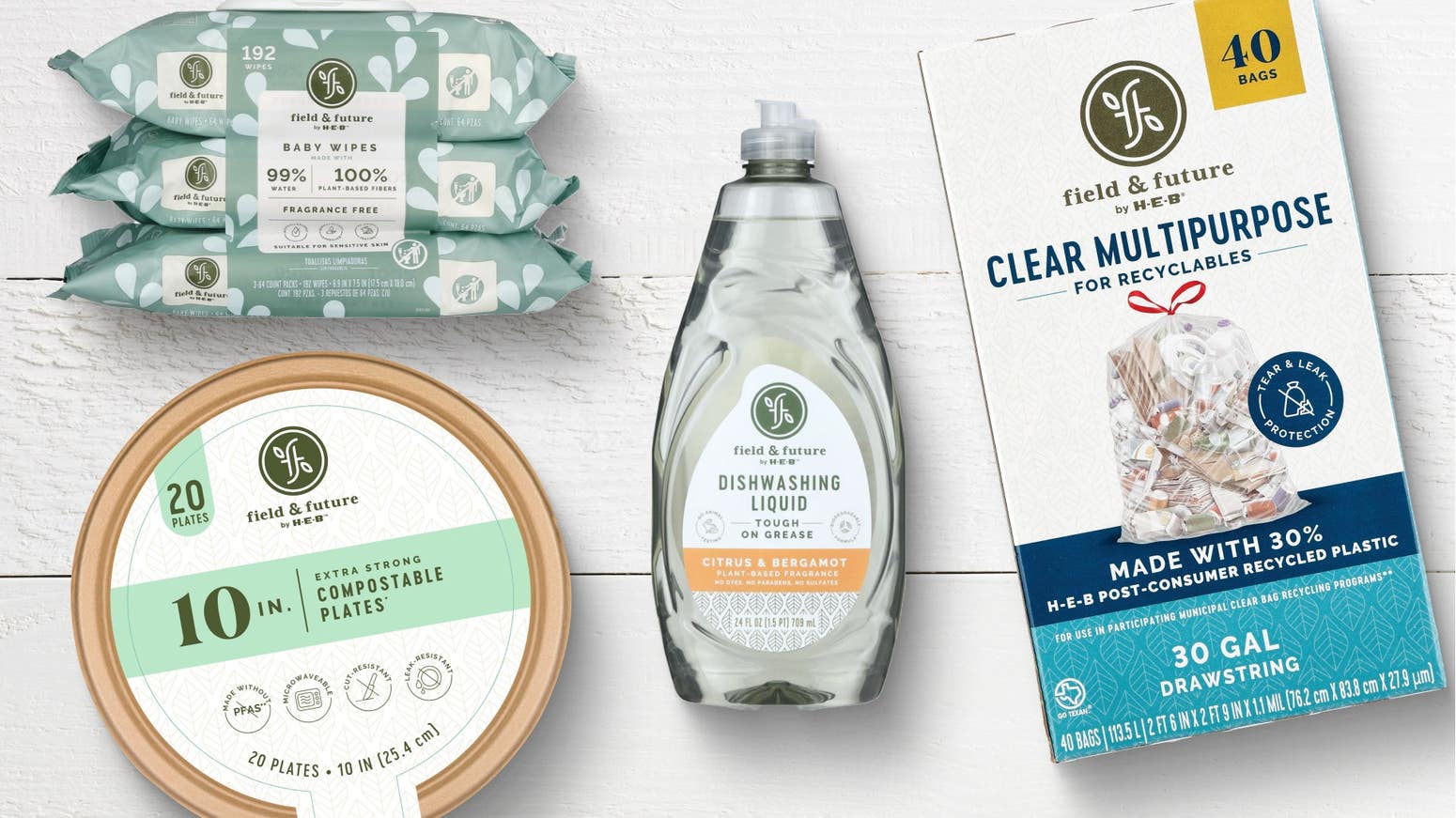 Field & Future by HEB eco-friendly home products: baby wipes, citrus & bergamot dish soap, 10-inch compostable plates, and clear multipurpose recycling bags.