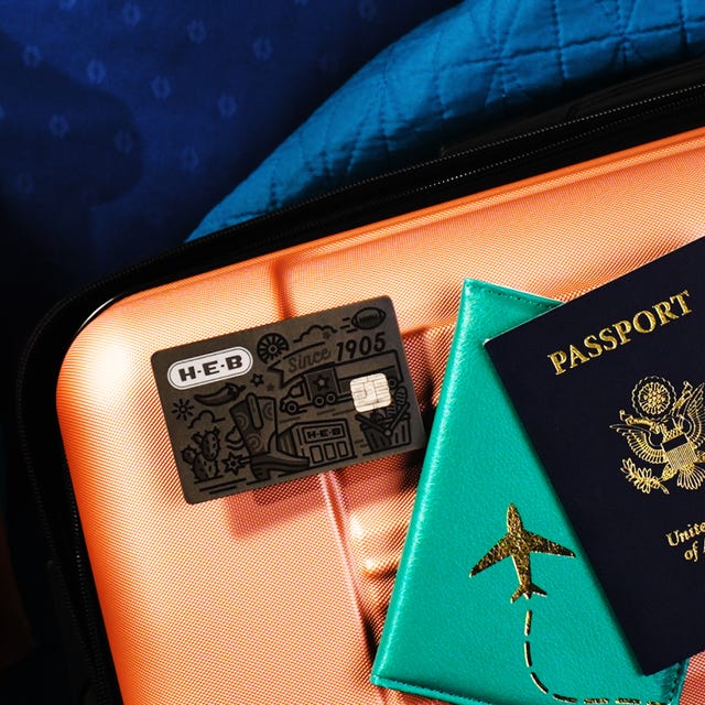 H‑E‑B Credit Card on top of luggage and a passport