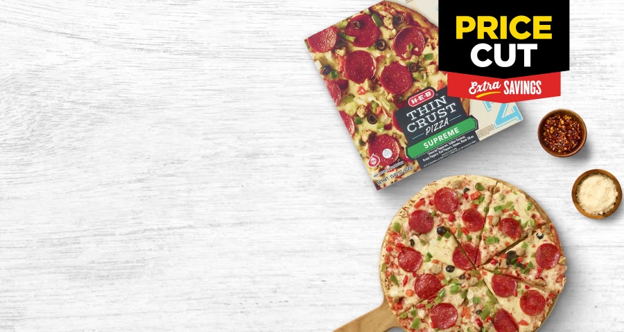 H‑E‑B Rising Crust pizza box open with the pizza lying besides it