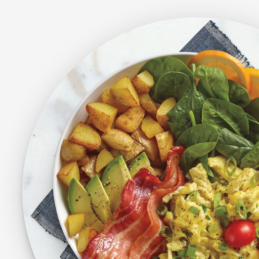 Breakfast hash with egg, bacon, avocado, spinach, and potato