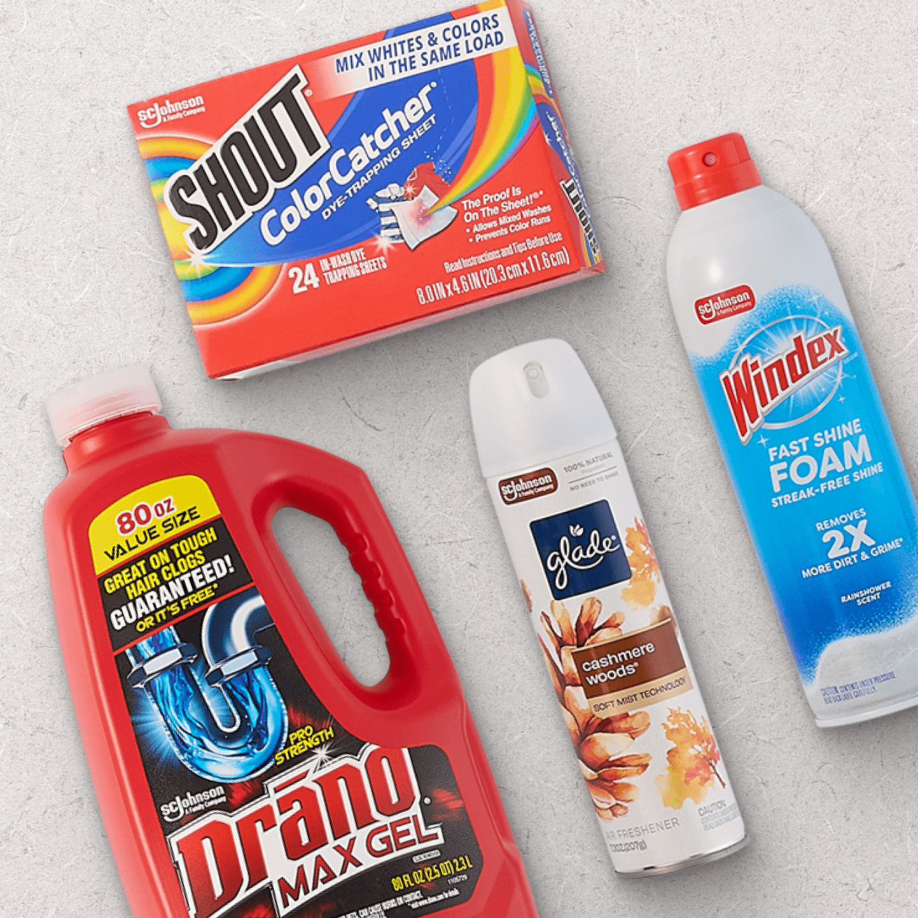 Shout Color Catcher dye trapping sheets, Drano Max Gel drain cleaner, Glade Cashmere Woods air freshener, and Windex Fast Shine Foam cleaner on a light gray surface.