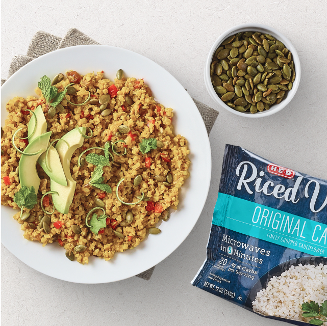 Riced cauliflower dish with peppers, herbs, and avocados